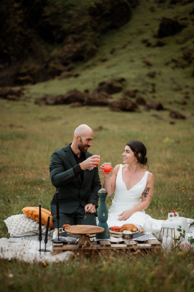 bride and groom share a picnic during their iceland wedding.