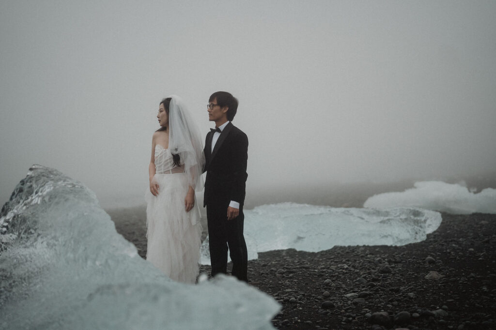 bride and groom on diamond beach during adventure elopement photos in iceland.