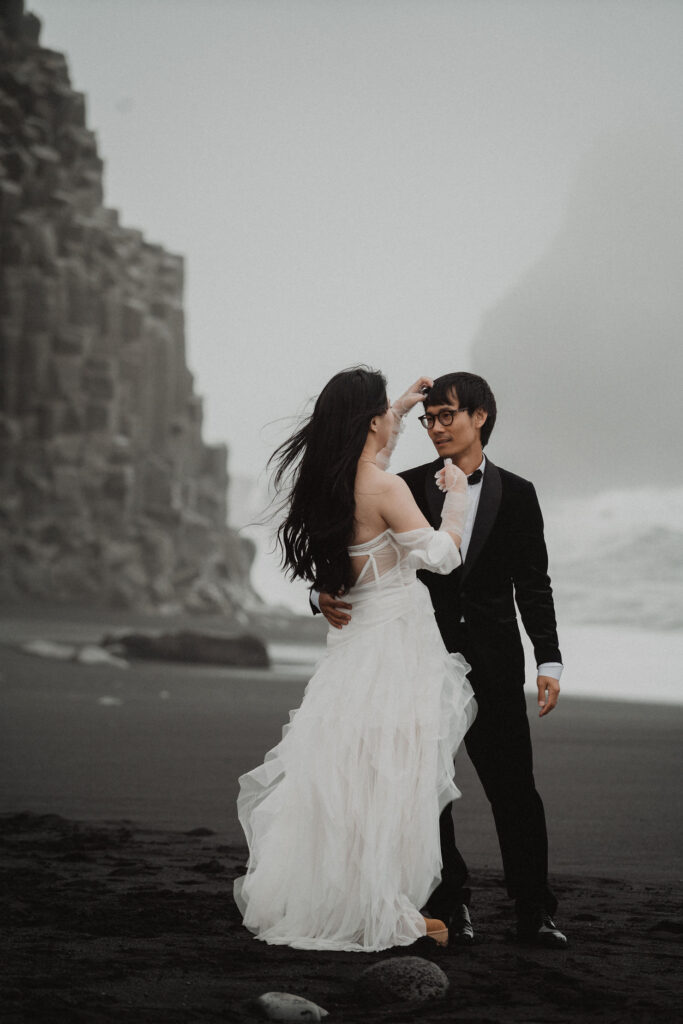 bride and groom embrace on diamond beach during iceland wedding photo session.