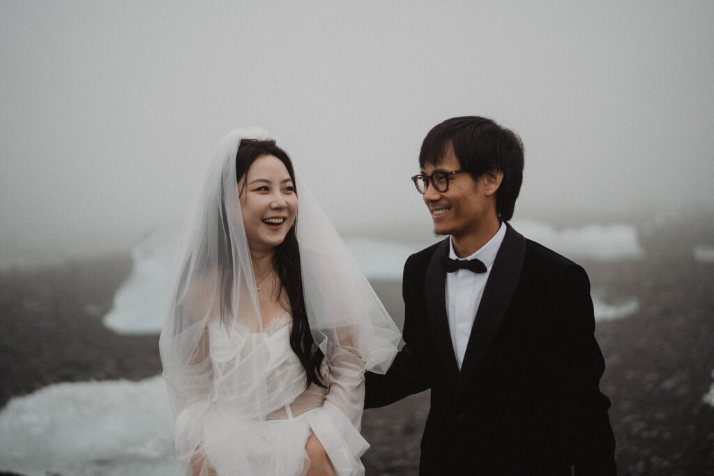 bride smiles at groom during iceland wedding photo shoot.
