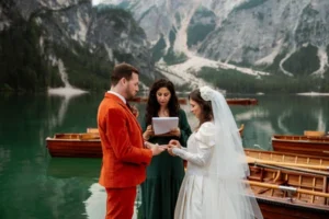 bride and groom stand in front of Lago di Braies during dolomites elopement