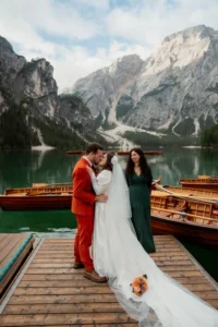bride and groom kiss in front of Lago di Braies during dolomites elopement ceremony