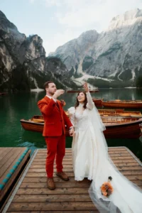 bride and groom celebrate during dolomites elopement at Lago di Braies