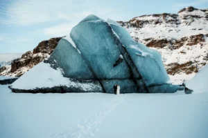 bride and groom stand in front of glacier at Solheimajokull Glacier, one of the best place in iceland to elope