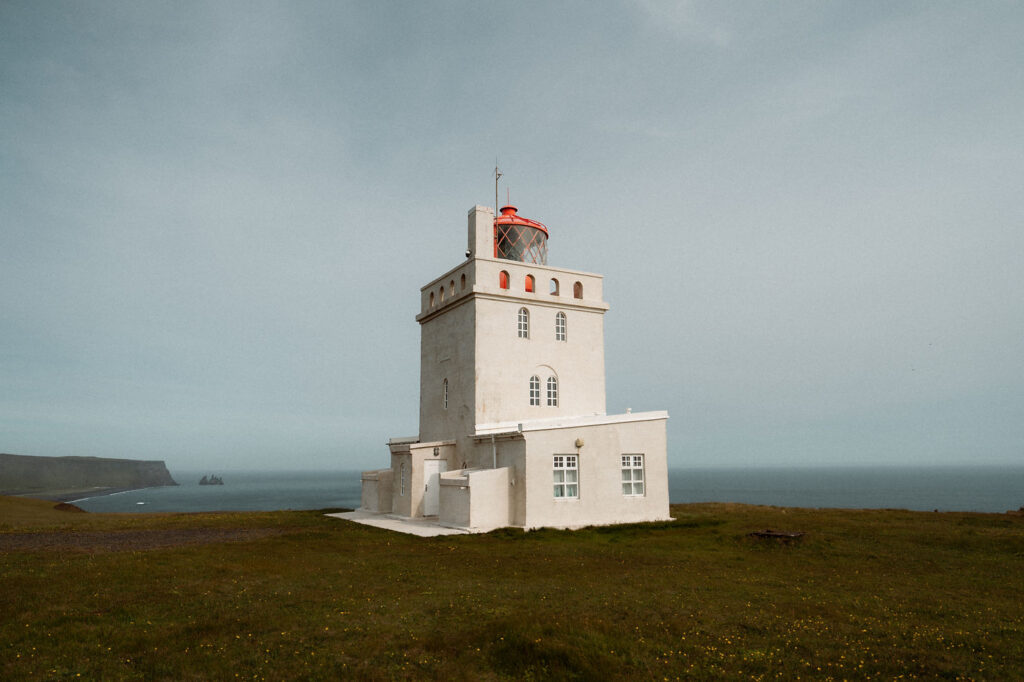 dyrholaey lighthouse in iceland cliffs and black sand beach