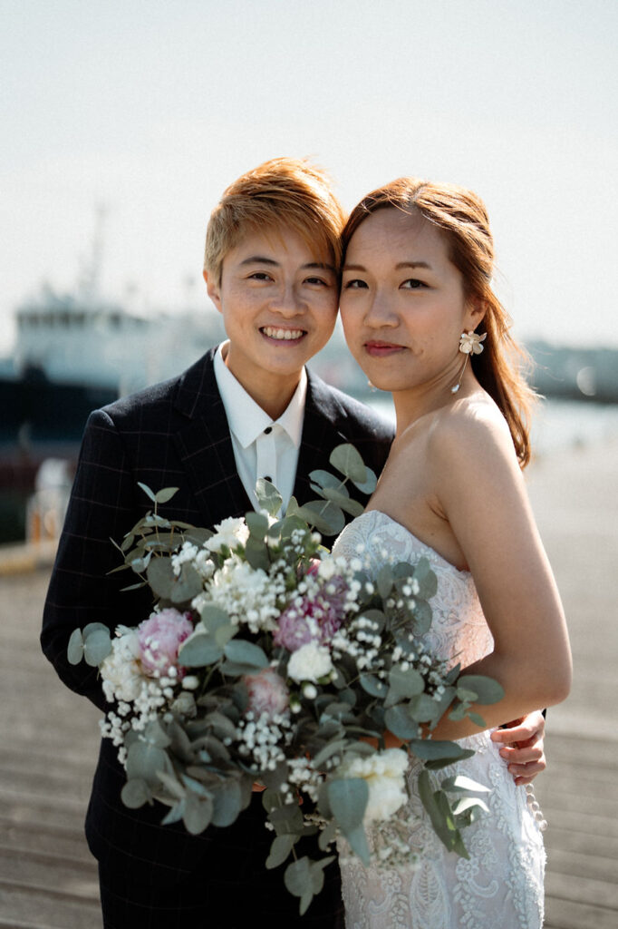 lgbtqi+ couple smiles at iceland elopement photographer during their destination wedding.